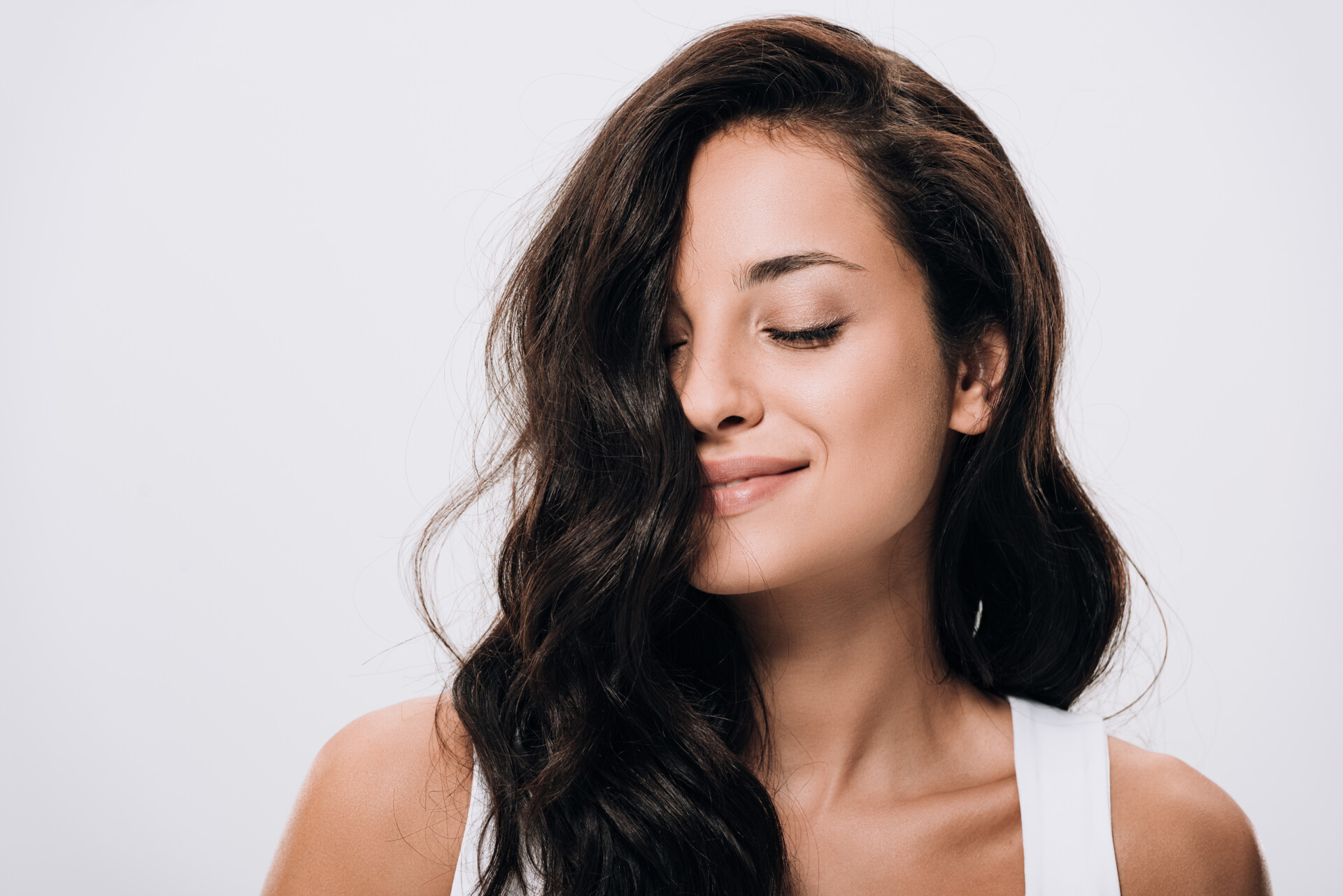 VistaCreate-308640452-stock-photo-smiling-brunette-beautiful-woman-closed-eyes-long-healthy-shiny-hair